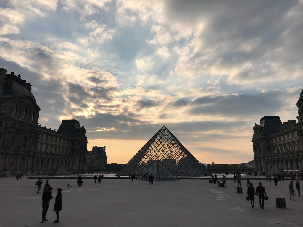Main courtyard of the Louvre Palace in Paris with glass pyramid in view