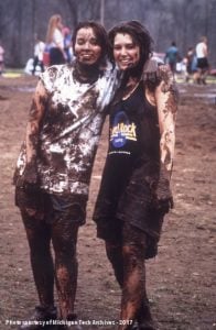 Two students covered in mud after an oozeball game.