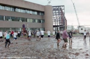 Students playing oozeball on the lawn in front of Walker Hall.