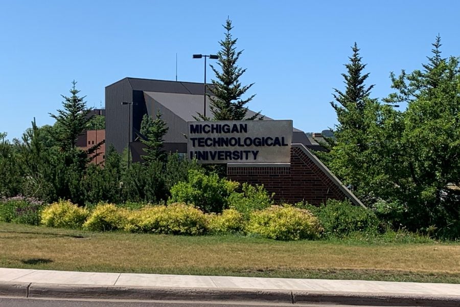 Summer image of the Michigan Technological University sign at the east end of campus.