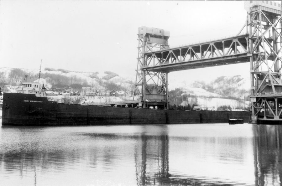 Henry Steinbrenner (1), formerly known as the Verona, passing under the Portage Lake Lift Bridge in November 1965. Image courtesy of the Ben Chynoweth Collection held by the Michigan Tech Archives.