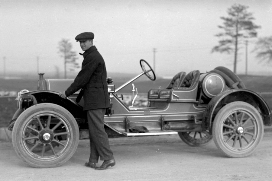 Unidentified man shows off Ford automobile.