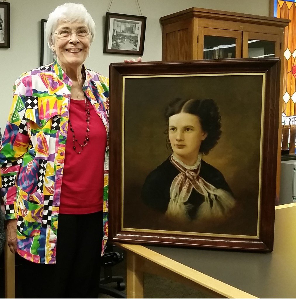 Donor Jane Libby and Archivist Lindsay Hiltunen pose with the framed portrait of Christeen M. Shelden, daughter of local historic figure Ransom B. Shelden. The painting was donated to the Michigan Technological University Archives and Copper Country Historical Collections on Monday, June 20. 