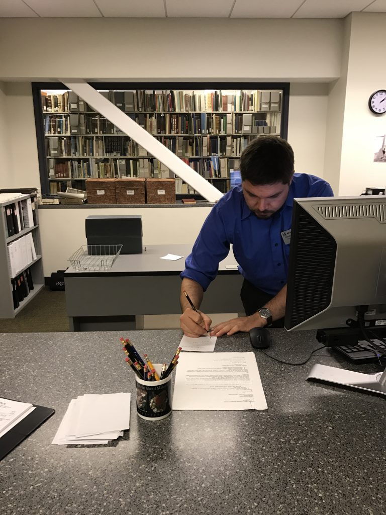 Steve is hard at work assisting a patron with some genealogical research. 