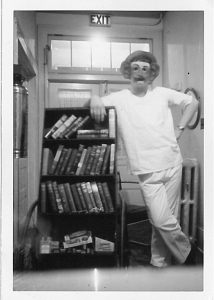 A masked person at the Copper Country Sanatorium takes the bookshelf for a spin.