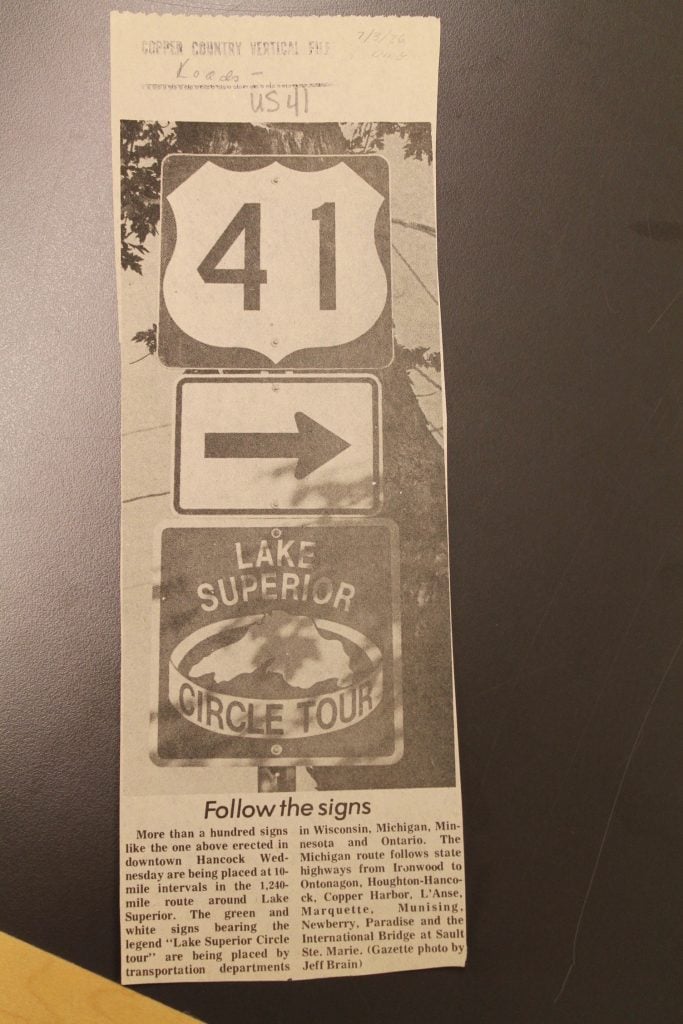 Daily Mining Gazette article on installation of the first “Lake Superior Circle Tour” reassurance shield signage, from the Roads – US 41 folder, Copper Country Vertical Files, Michigan Technological University and Copper Country Archives.