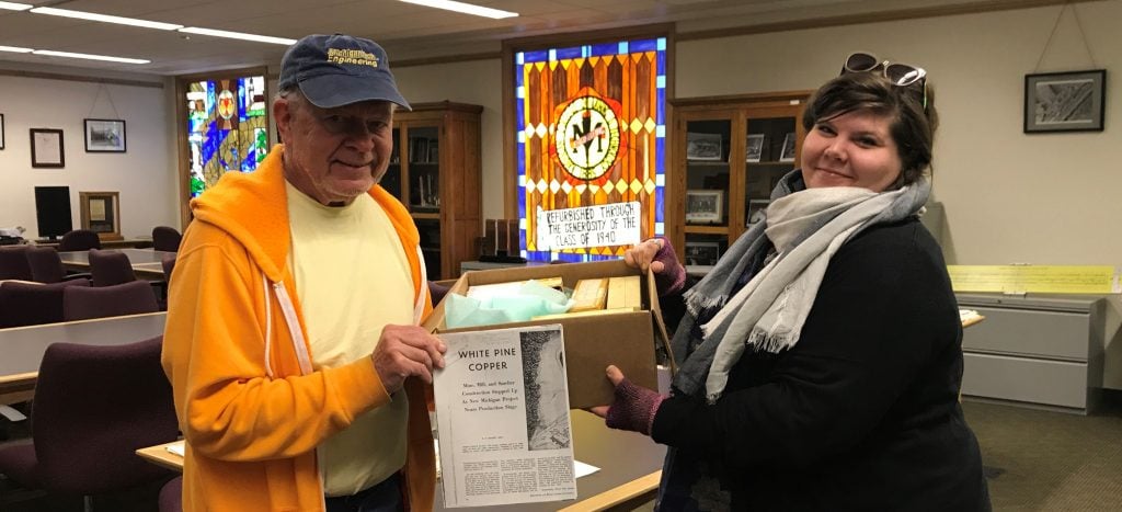 Roger Hewlett delivers the White Pine Copper Company slide collection to university archivist, Lindsay Hiltunen in May 2018. 