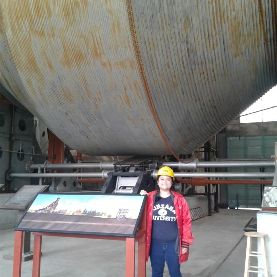 Angie standing under the Nordberg steam hoist in the 1917 hoist house on the Quincy Mine site. The Nordberg is the largest steam hoisting engine in the world. 