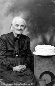 Elderly woman with birthday cake