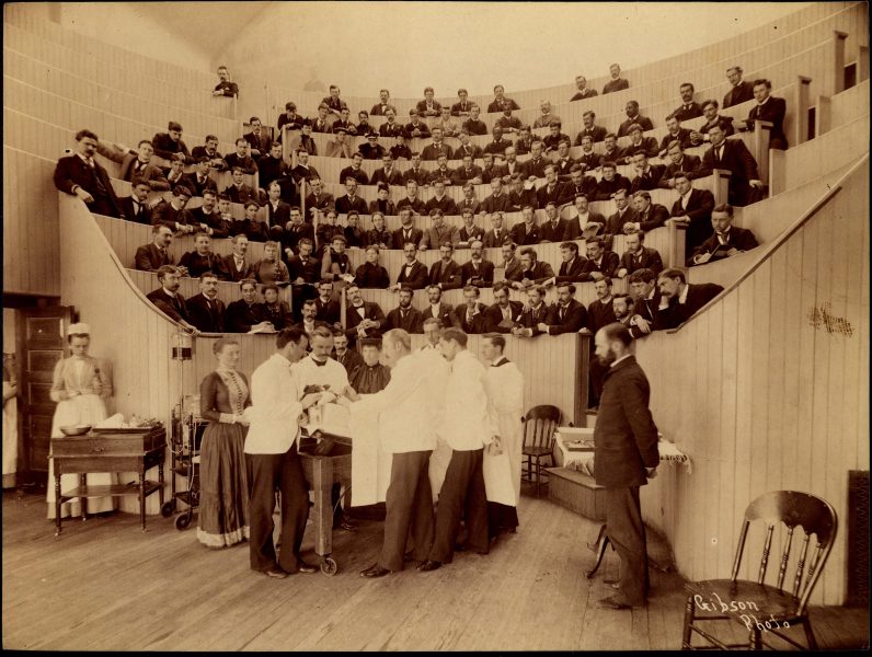 Image of people in auditorium attending a medical demonstration