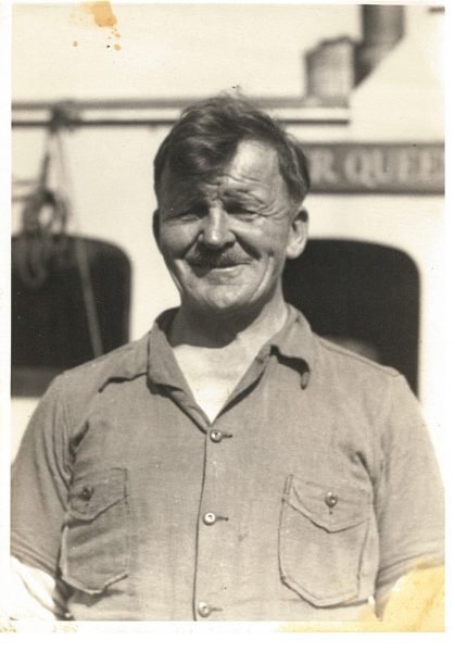 Man in front of boat