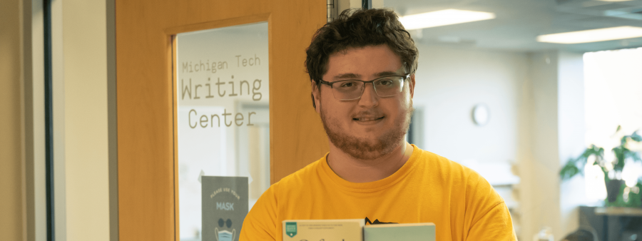 Tucker Nielsen stands in front of the Michigan Tech writing center.