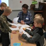 Justin helping students calculate their heart rate zones for an experiment.