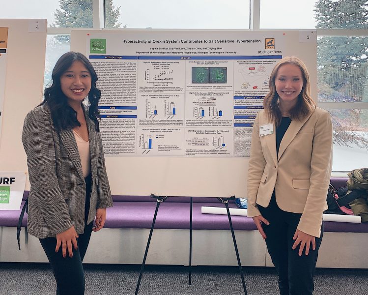 Image of Michigan Tech students presenting research poster