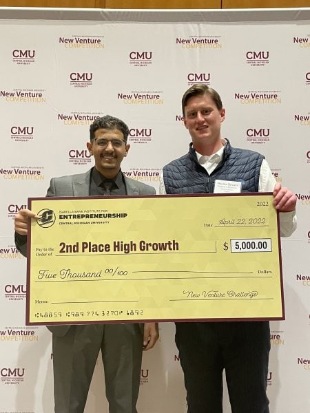 Ali Dabas and Rourke Sylvain holding the 2nd place high growth check for five thousand dollars.