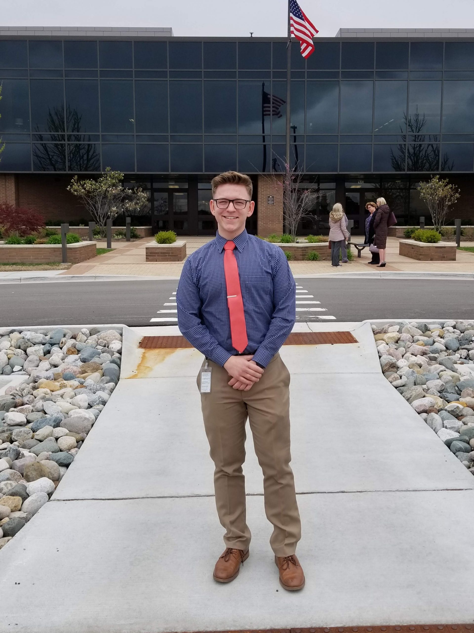 Student stands in from of Auto-Owners Insurance