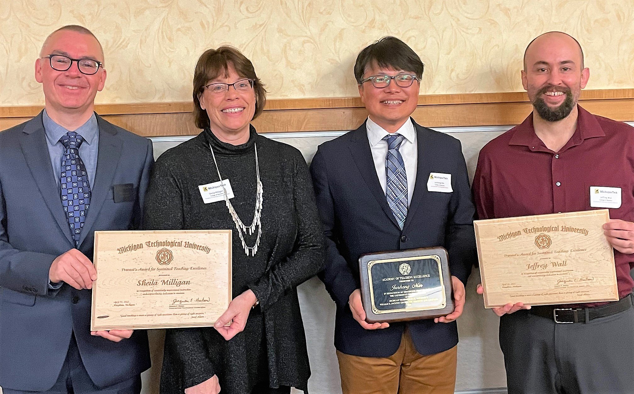 photo of four MTU business faculty with plaques