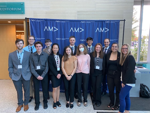 Picture of American Marketing Association group of students standing in front of AMA step-and-repeat backdrop.  