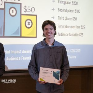 Student Alex Bos posing with certificate