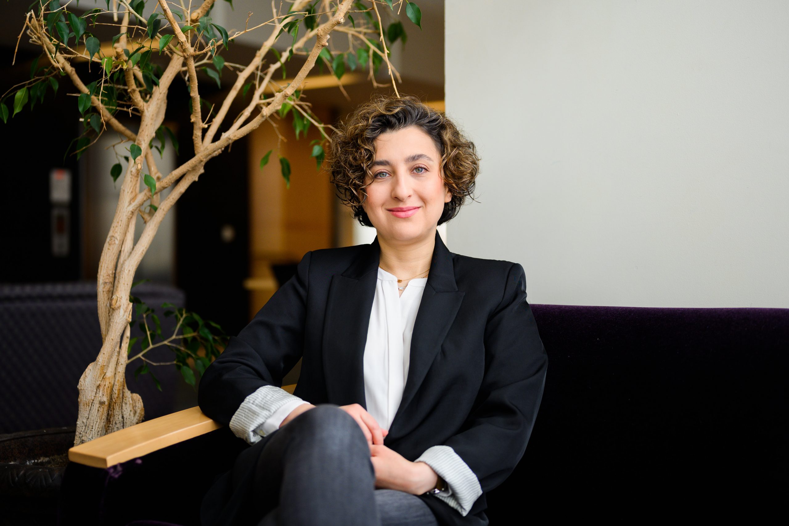 Elham (Ellie) Asgari, assistant professor of management and entrepreneurship, poses in the library