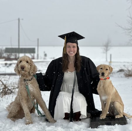 Photo of Jada Hamar flanked by two dogs