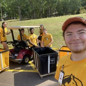 Anderson Piercey and other MTU students with a golf cart