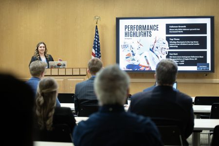 Ruby Walker proudly presenting at Spotlight Night after a year of successful community marketing support.