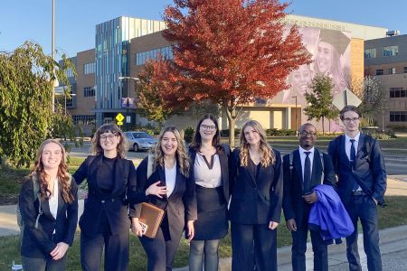 Michigan Tech AMA students pose together, smiling and ready to compete at the UW-Whitewater Regional Conference.