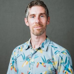 Professional headshot of Ryan Neely in an indoor studio