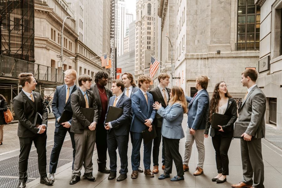 Applied Portfolio Management Program students and faculty mentor Laura Sieders explore Wall Street’s marble canyon during the group’s annual trip to the lower Manhattan financial district. (Image credit: Megan Thompson)