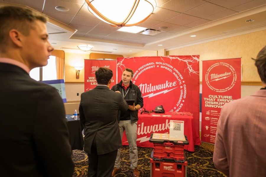 Student speaker to a recruiter at the Milwaukee Tool both.