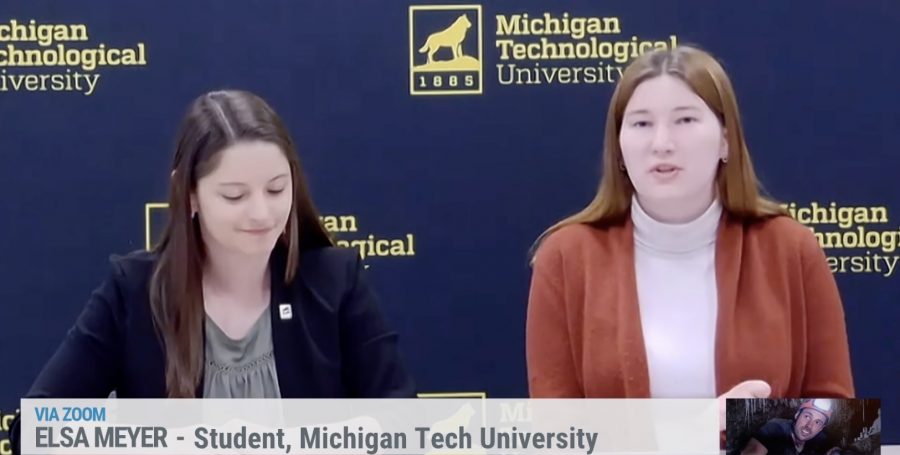 Two women interviewed in front of a Michigan Tech backdrop.