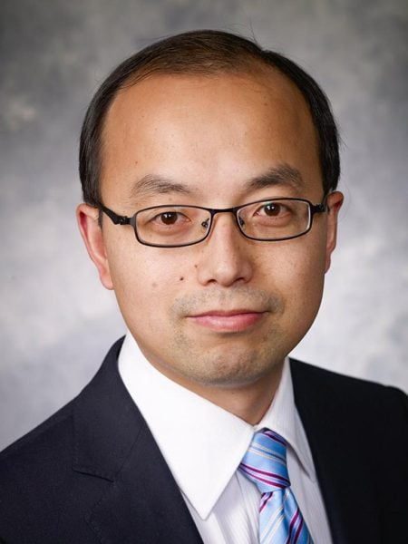 Professional in-studio headshot of Zhiqiang Lin with a gray background