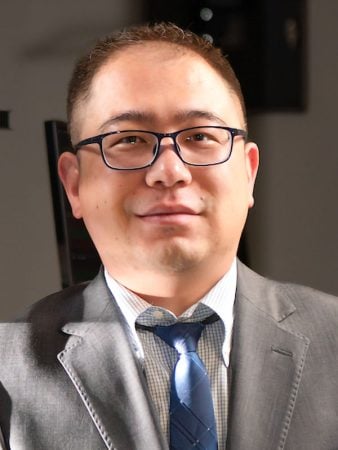Bo Zhang professional headshot in a studio with a white background