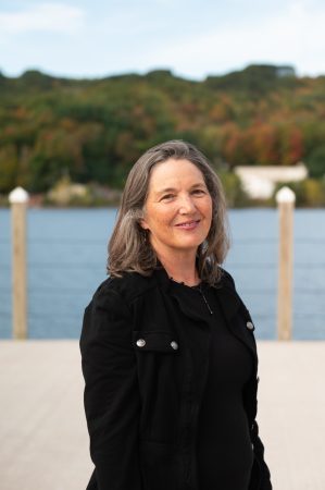 Outdoor portrait of Dianne Marsh, a College of Computing Honor Academy inductee at Michigan Tech, with fall colors along the Portage Canal in the background.