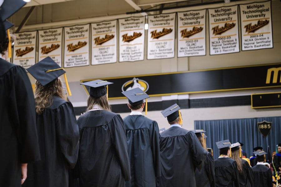 Back view of Michigan Tech graduates wearing caps and gowns during Midyear Commencement.