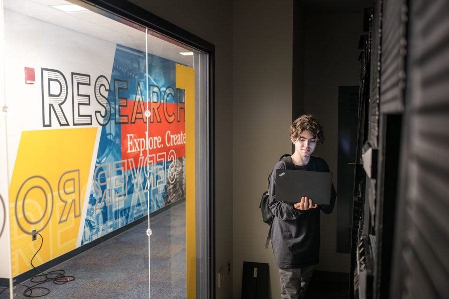 Cybersecurity student Noah Holland in a Michigan Tech College of Computing server room.
