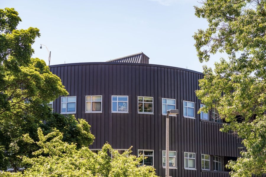 An exterior shot of Michigan Tech’s Rekhi Hall in the green of late summer.
