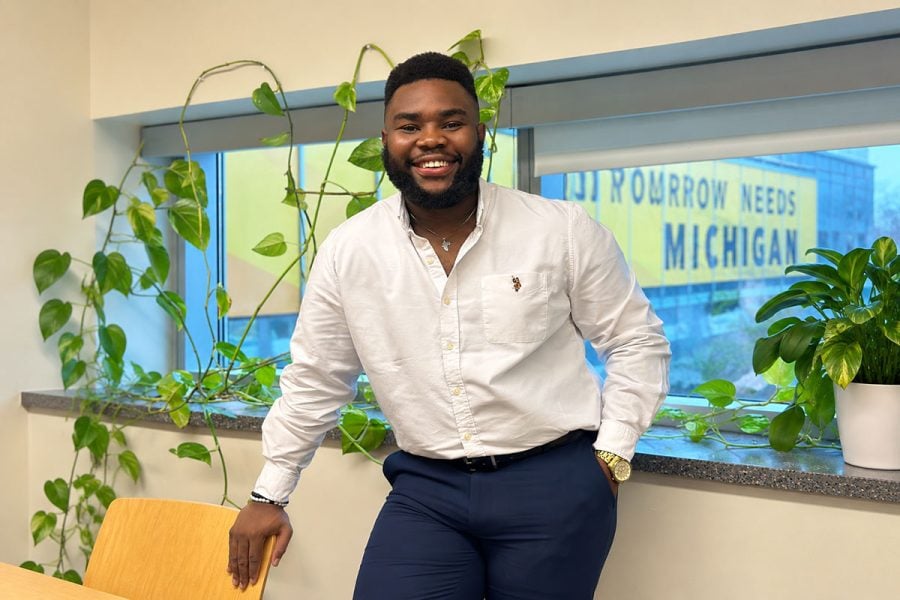 A Michigan Tech College of Computing student researcher smiles in the College of Computing Lounge at the University.