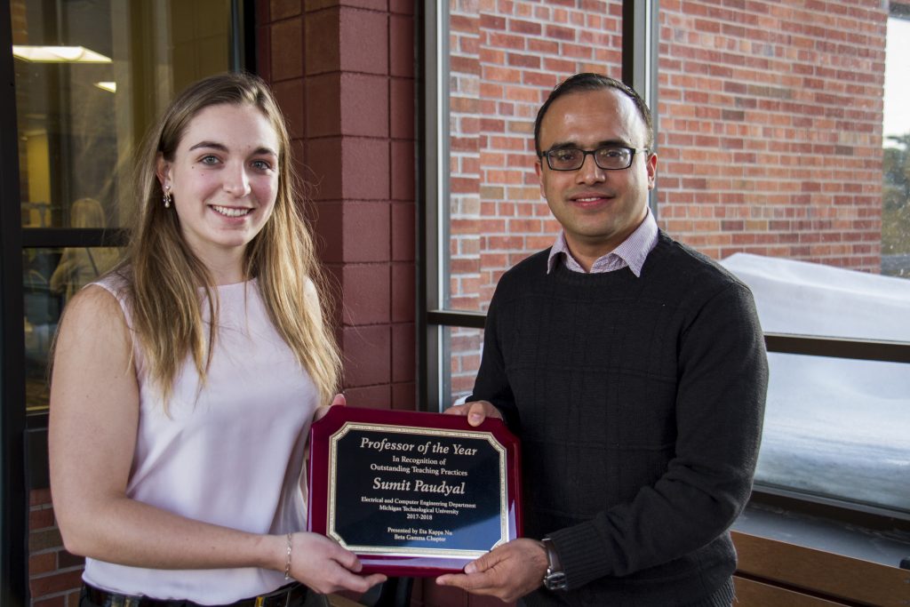 HKN representative Sandra Cvetanovic presents the Professor of the Year Award to Sumit Paudyal