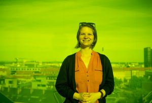 Hannah Cunningham '18 BME, pictured here in the colored-glass walkway at the Aros Art Museum in Denmark. Credit: Taran Schatz 