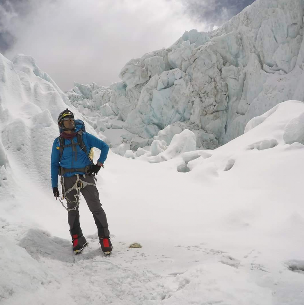 Sirak Seyoum stands in front of what seems to be a massive crevasse on his climb up Mount Everest