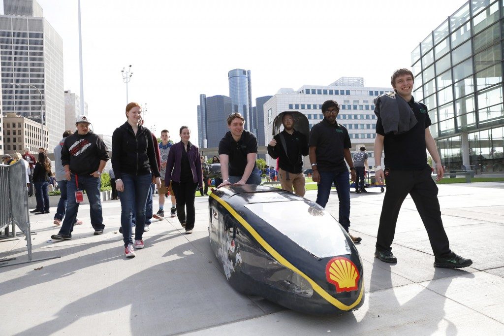 Students outside with their vehicle