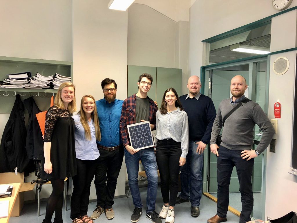 Amber Kauppila and the Floating Solar Panel Park design team at Novia University of Applied Sciences in Vaasa, Finland. One student holds a small solar panel.