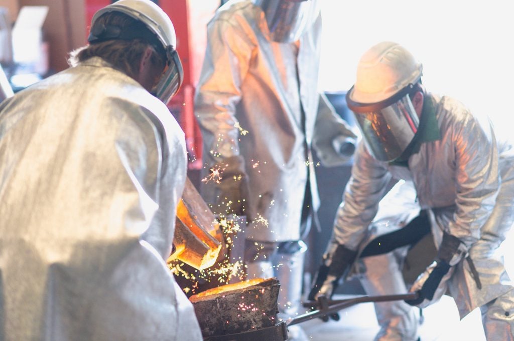 After tapping into the ladle is complete, some sparks fly as the inoculant reacts with the liquid iron.