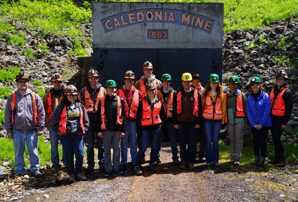 A class of 14 Michigan Tech field geology students stand at the entrance of the Caledonia Mine, Ontonagon County, Michigan. Photo courtesy of Steve Chittick.