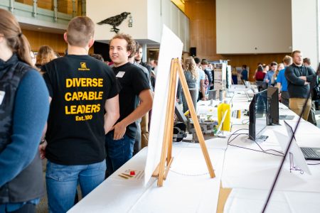 Sudents take part at design Expo while at their tables and posters.