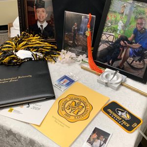 A table with Zachary's diploma, and other photos and mementos.