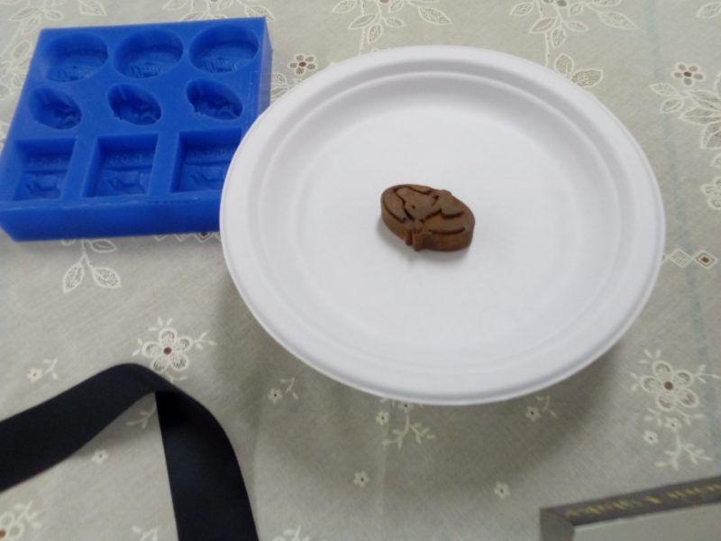 oval-shaped chocolate on a plate with a Keweenaw peninsula design on the top.