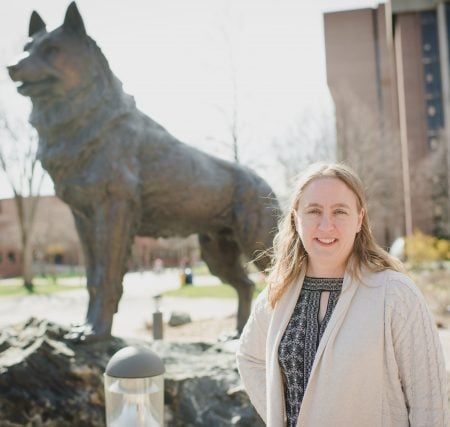 Caryn Heldt in front of the Husky Statue.